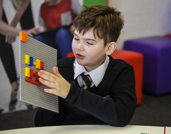 Child playing with Lego's new braille bricks