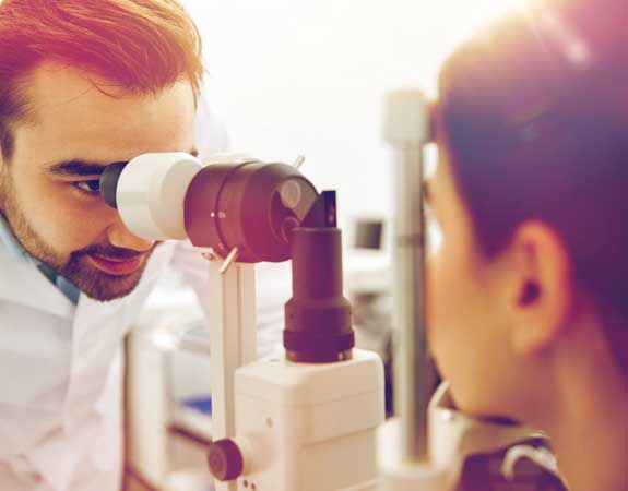Optician administers a Tonometer to a young patient living with Cataracts. Covid 19 eye care