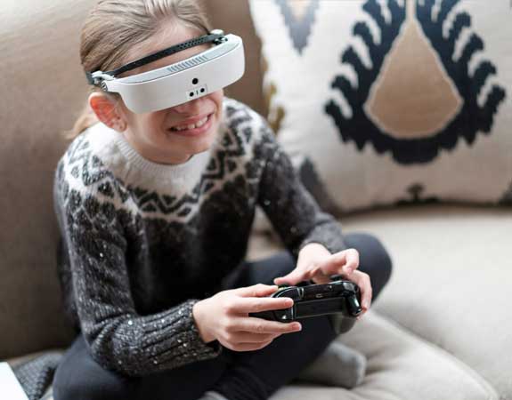 Young girl plays video games using her eSight