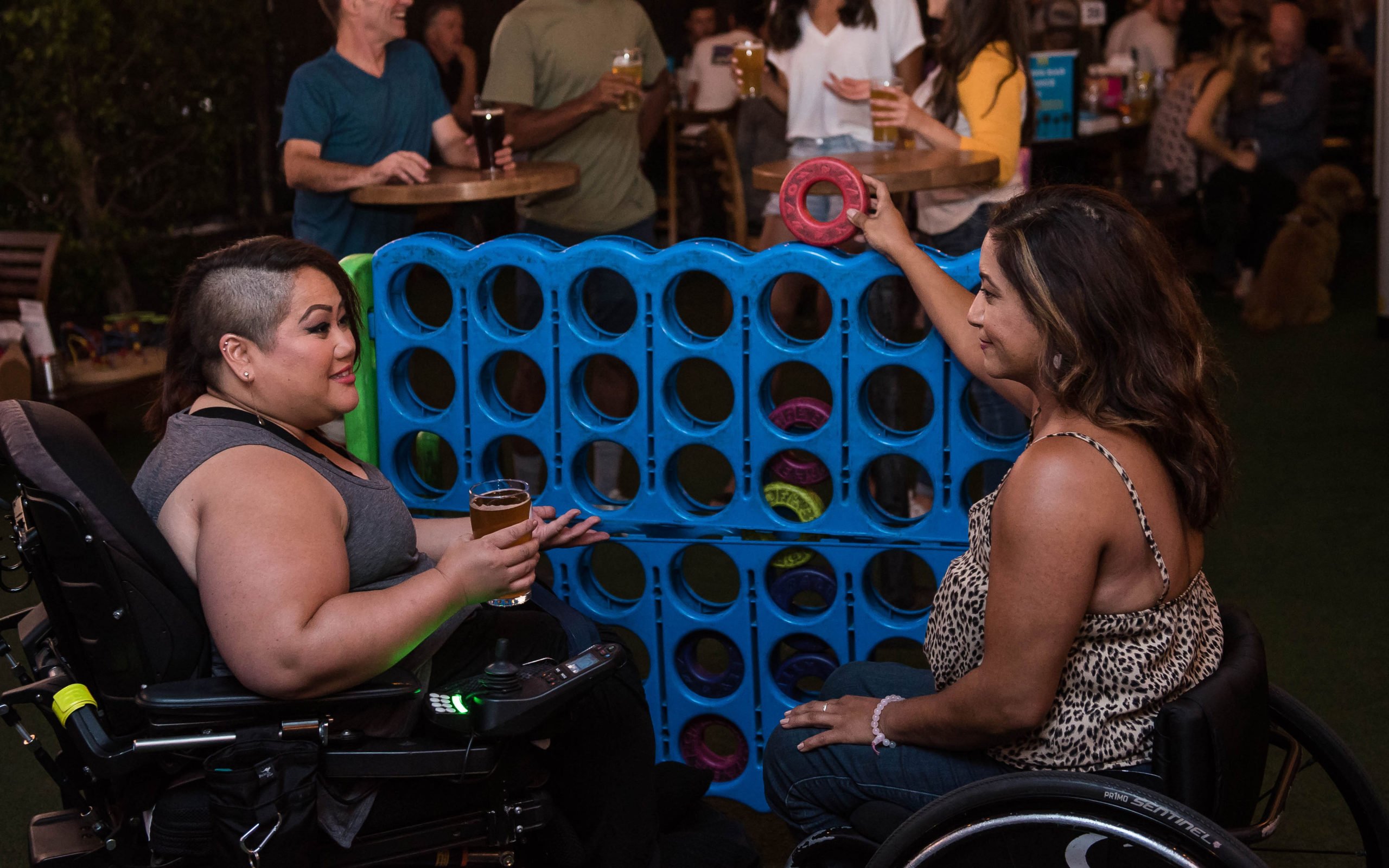 Women in wheelchairs playing in a bar