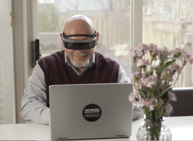 Remote employee wearing eSight assistive technology for visually impaired