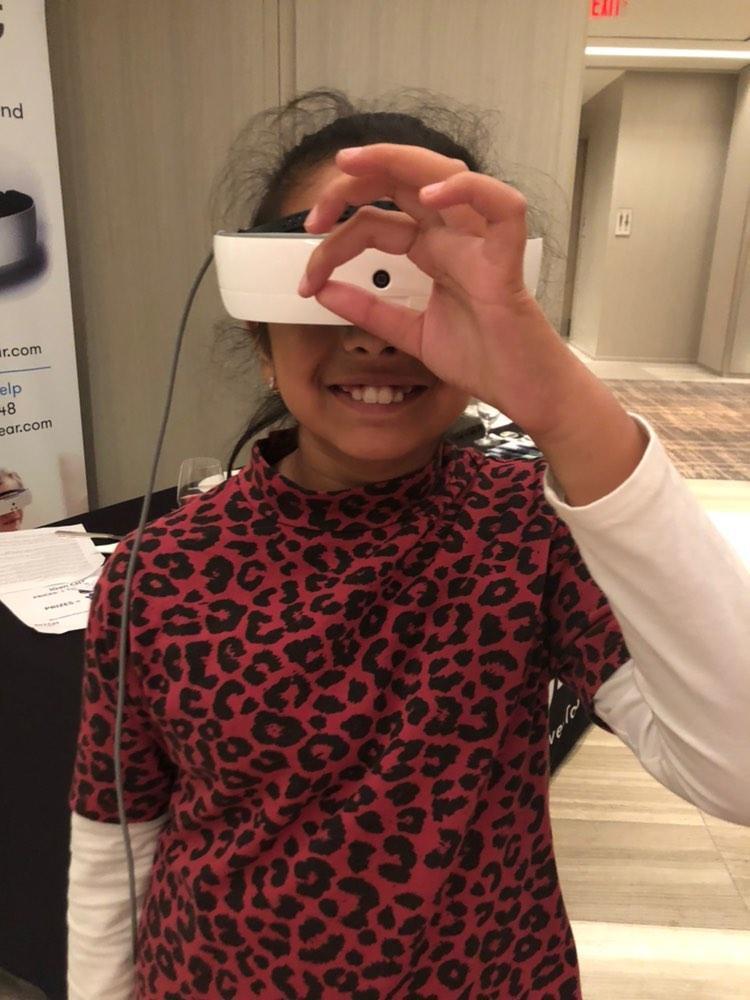 10 year old Zara smiling while wearing her eSight 4.
