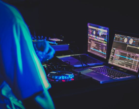 Man working on music on his computer. A visual depiction of the nature of Shane's work as a radio host.