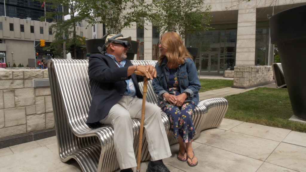 Gary Foster, sitting with his wife. Gary is a long term eSight user and macular degeneration patient.