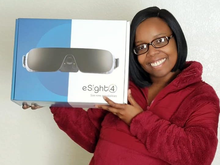 Jessica Jackson, eSight user holding her eSight 4 box.