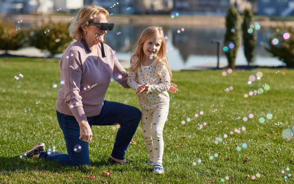 Girl and woman playing with bubbles