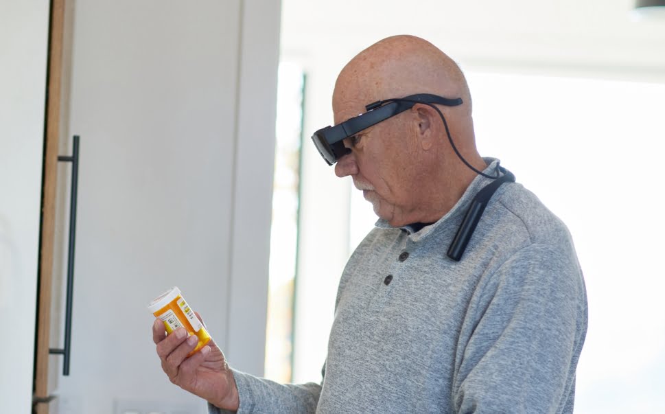 Man looking at prescription bottle