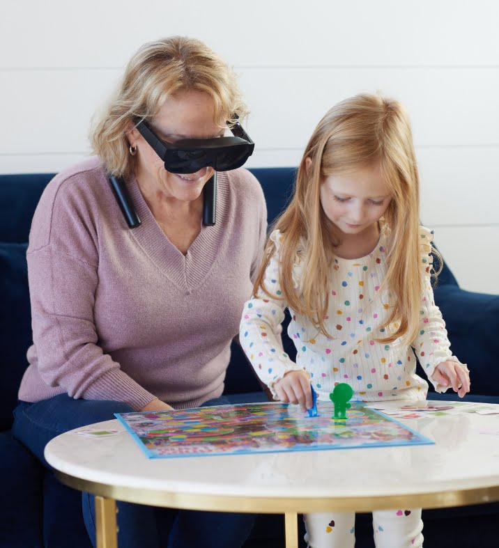 Woman reading book with little girl