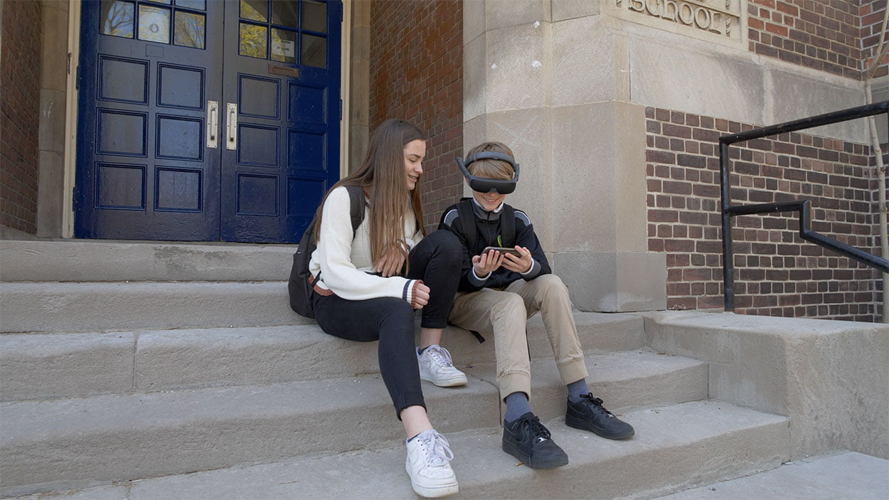 Kids on school steps using eSight